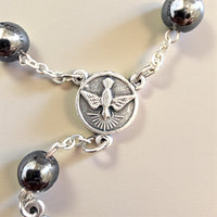 
              Peace & Protection Catholic Rosary Bracelet – Handmade Hematite Pocket Rosary with Holy Spirit Medal
            