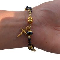
              Elegant Womans Black Crystal Bead Bracelet With Gold Crucifix And Virgin Mary Medal Double Layered With Gold Accents
            